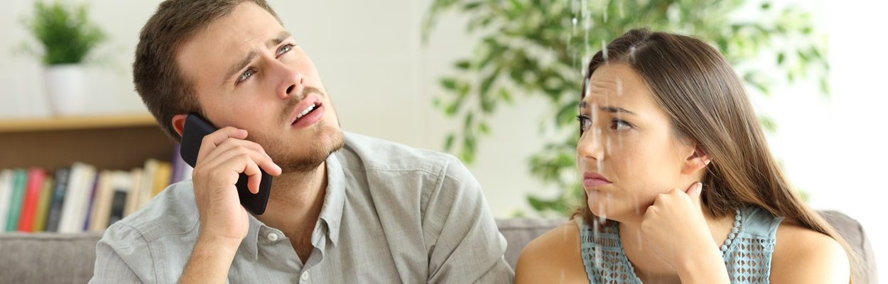 Couple On Couch With Leaking Roof