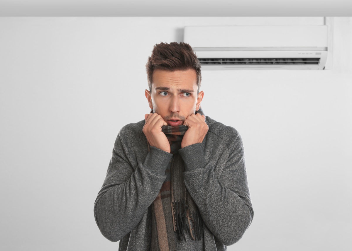 Common Reasons Florida Homes Experience Uneven Cooling (1) Technician inspecting ductwork to fix uneven cooling in a Florida home